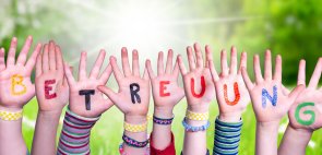 Kinderhände mit der Aufschrift Betreuung